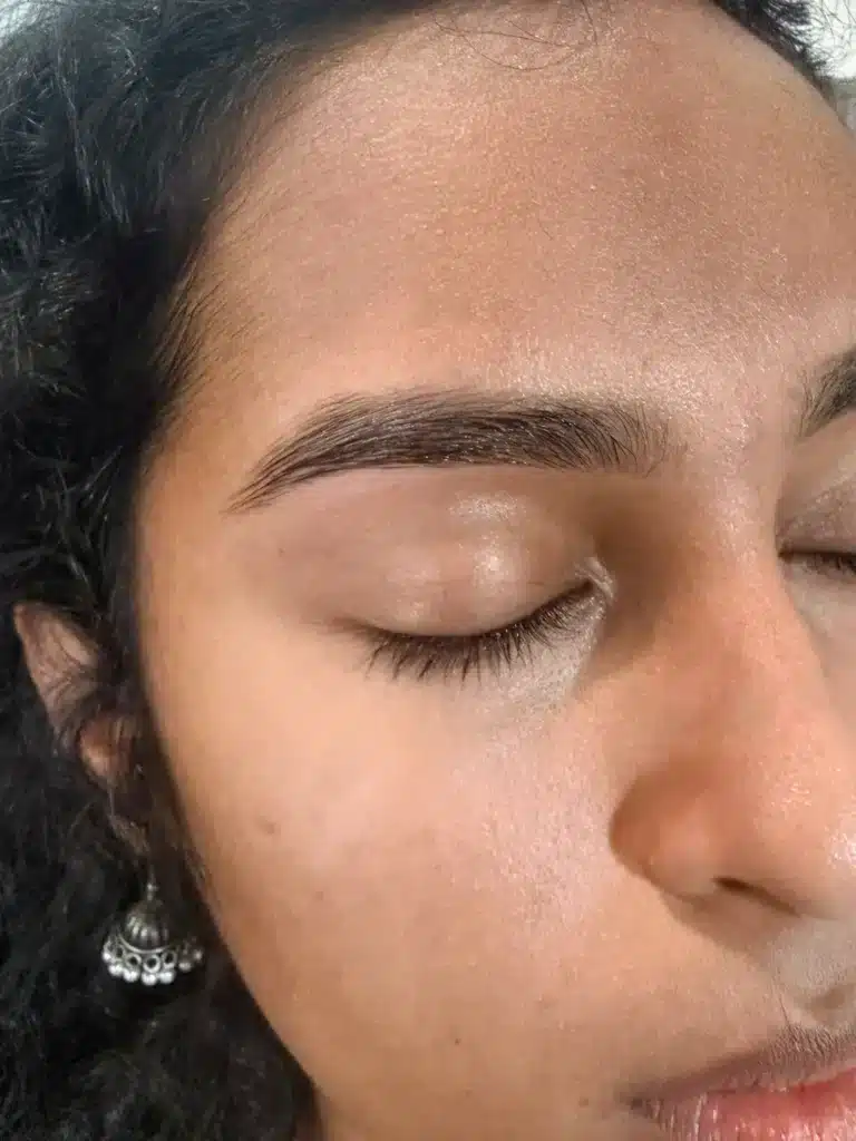 Close-up of eyebrow threading with precise shaping and natural full brow finish.
